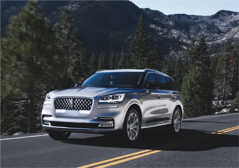 A 2023 Lincoln Aviator® Grand Touring SUV being driven on a winding road to demonstrate the capabilities of all-wheel drive | West Point Lincoln of Sugar Land in Houston TX