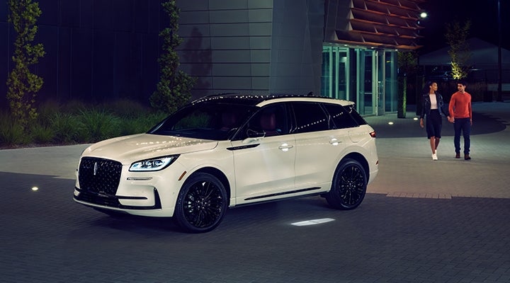 Two people approach a 2024 Lincoln Corsair® SUV featuring the available Jet Appearance Package. | West Point Lincoln of Sugar Land in Houston TX