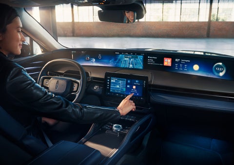The driver of a 2024 Lincoln Nautilus® SUV interacts with the center touchscreen. | West Point Lincoln of Sugar Land in Houston TX