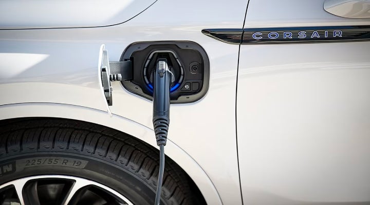 An electric charger is shown plugged into the charging port of a Lincoln Corsair® Grand Touring
model. | West Point Lincoln of Sugar Land in Houston TX