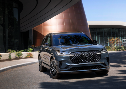 A gray 2025 Lincoln Aviator® SUV is parked outside a modern building with the sun shining. | West Point Lincoln of Sugar Land in Houston TX