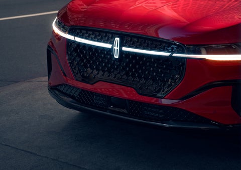 The available front LED light bar and center Lincoln Star logo glow at dusk. | West Point Lincoln of Sugar Land in Houston TX