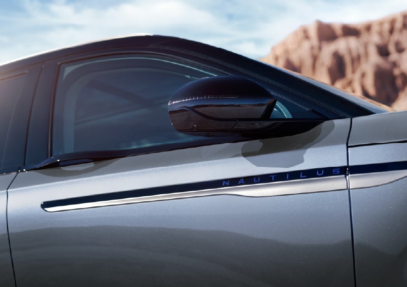 Blue lettering on the side of the vehicle that reads Nautilus indicates the available Hybrid Powertrain. | West Point Lincoln of Sugar Land in Houston TX