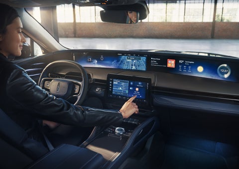 The driver of a 2026 Lincoln Nautilus® SUV interacts with the center touchscreen. | West Point Lincoln of Sugar Land in Houston TX