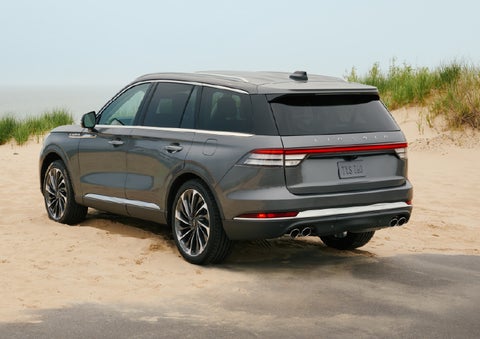 A 2027 Lincoln Aviator® SUV is parked next to sand dunes. | West Point Lincoln of Sugar Land in Houston TX