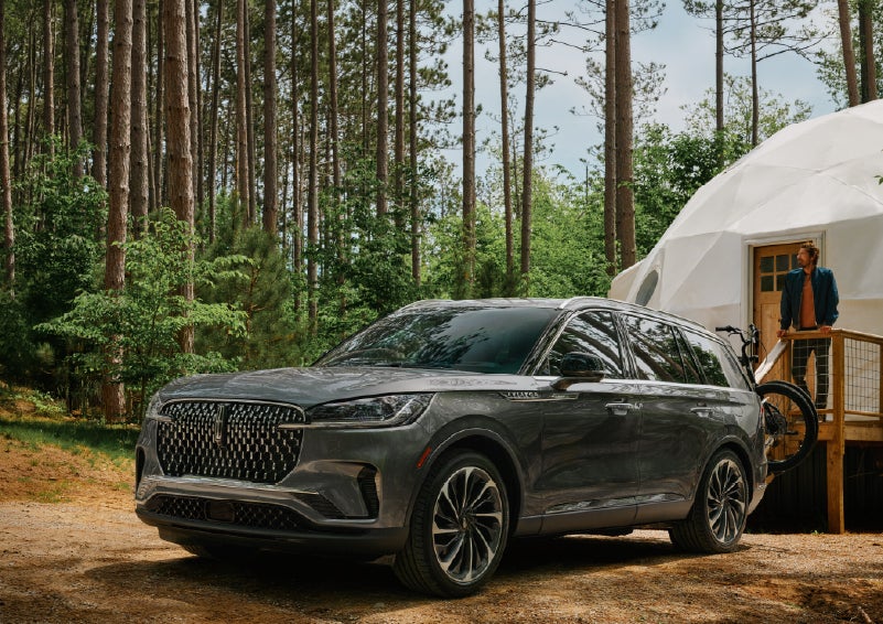 A 2027 Lincoln Aviator® is parked next to a high end glamping site. | West Point Lincoln of Sugar Land in Houston TX