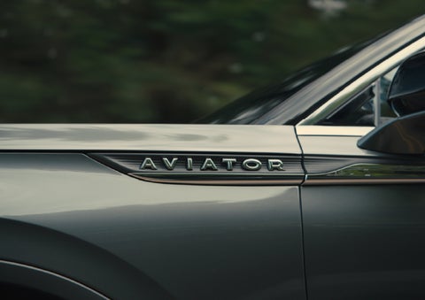 The driver’s side door and fender badging of a gray 2027 Lincoln Aviator® SUV are showcased. | West Point Lincoln of Sugar Land in Houston TX