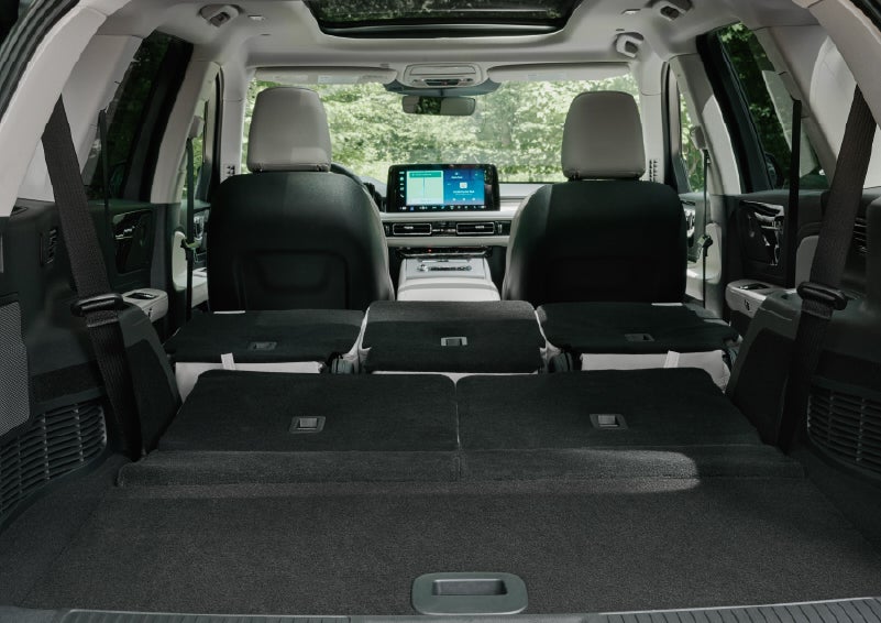 A rear to front view of the interior of a 2027 Lincoln Aviator® Black Label™ SUV shows the third and second rows folded flat | West Point Lincoln of Sugar Land in Houston TX