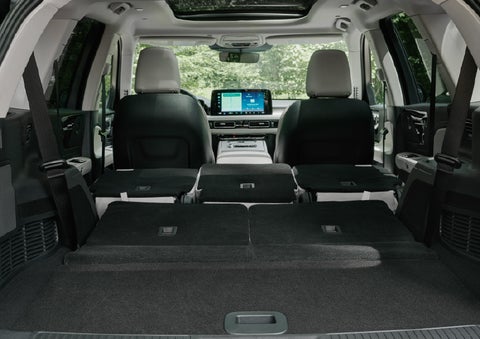 A rear to front view of the interior of a 2027 Lincoln Aviator® Black Label™ SUV shows the third and second rows folded flat | West Point Lincoln of Sugar Land in Houston TX