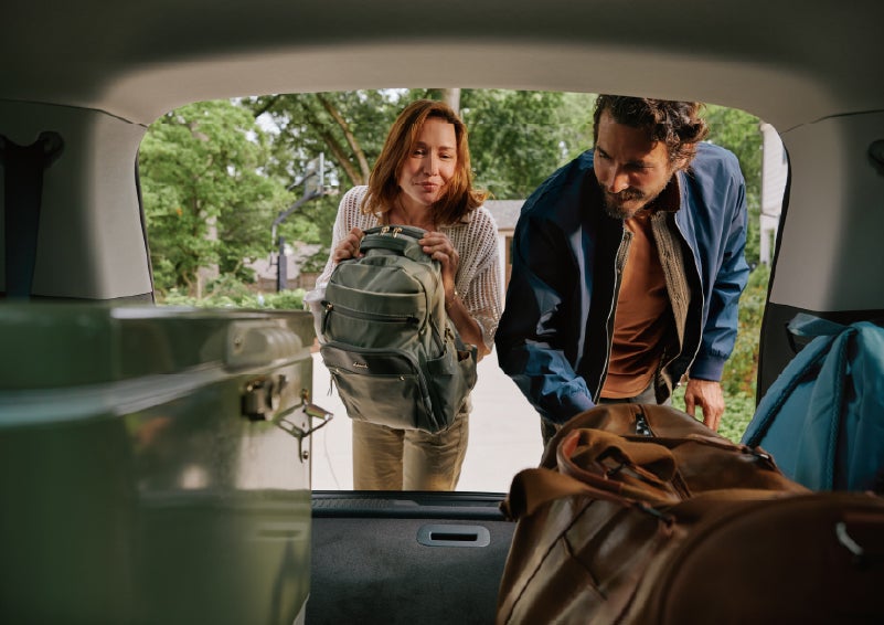 A couple loads luggage into the rear of a 2027 Lincoln Aviator® Black Label™ SUV..e 202 | West Point Lincoln of Sugar Land in Houston TX