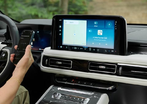 A person pairs thier phone with the center touchscreen of a 2027 Lincoln Aviator® Black Label™ SUV | West Point Lincoln of Sugar Land in Houston TX